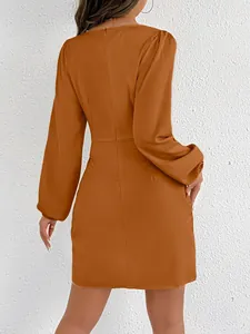 Detailed back view of a chic burnt orange satin long-sleeved mini bodycon dress with textured wall.