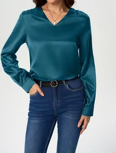 Detailed view of an elegant teal blue satin long-sleeved blouse featuring a V-neckline