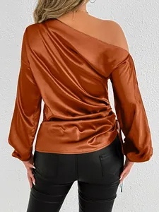 Detailed back view of an elegant copper satin one-shoulder blouse with lantern sleeves