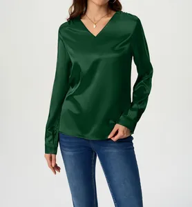 Detailed view of an elegant emerald green V-neck satin blouse featuring a luxurious silk-like finish