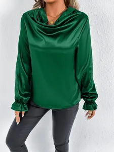 Close-up of green satin cowl neck blouse with elegant ruffled cuffs and silky texture