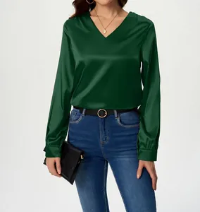 Detail of elegant V-neck green satin long sleeve blouse with silky texture
