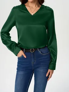 Detailed view of an elegant dark green long-sleeved satin blouse featuring a classic V-neckline