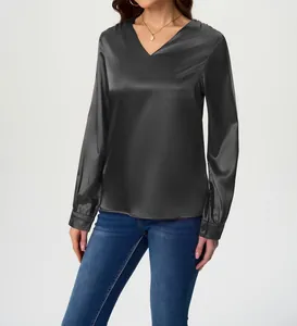 Detail view of an elegant glossy black satin long-sleeved blouse with a V-neckline