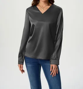 Close-up of elegant V-neck long sleeve satin blouse in dark grey silk-like fabric
