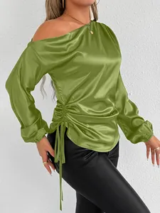 Detailed close-up of olive green satin long sleeve blouse featuring side drawstring ruched detail