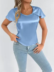 Detail view of light blue satin top showing flutter sleeves and silky fabric