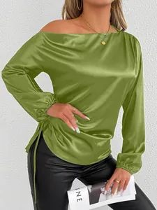 Close-up of green satin long sleeve blouse with off-shoulder neckline and drawstring