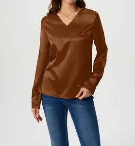 Close-up detail of women's brown long-sleeve satin blouse featuring a V-neck and silky finish