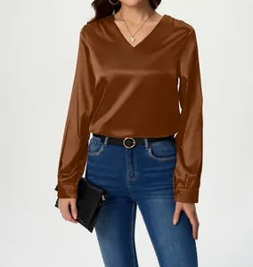 Close-up of elegant brown long-sleeve satin blouse with deep V-neckline for women