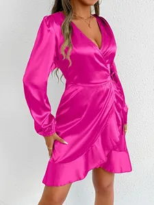 Detailed view of a fuchsia satin wrap dress with elegant ruffle hem and long sleeves