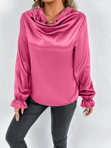 Detailed view of fuchsia satin cowl neck blouse with ruffled cuffs and smooth texture
