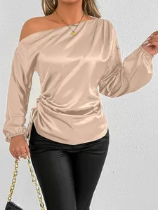 Detailed view of champagne satin blouse featuring elegant off-shoulder asymmetric design