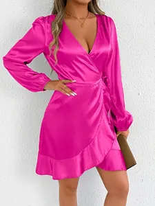 Elegant detail of magenta satin wrap dress with long sleeves and deep v-neckline