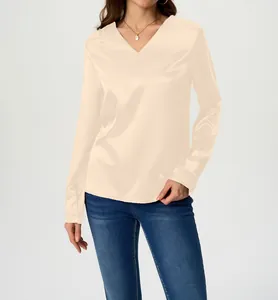 Elegant champagne long-sleeved satin blouse with V-neck detail shown on a model