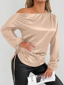 Detail of champagne satin off-shoulder long sleeve blouse featuring side ruching design