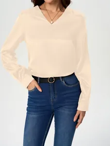 Detail view of a luxury satin long-sleeve blouse in apricot with a soft silky finish