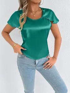 Close-up of elegant emerald green satin short-sleeved top with silky texture