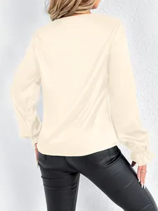 Rear view of elegant long-sleeve cream satin blouse featuring ruffled cuffs and silk-like texture