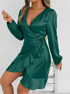 Elegant deep green satin long-sleeved wrap dress featuring a stylish ruffle hem and tie waist