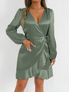 Detail view of a sage green satin wrap dress featuring an elegant ruffled hemline