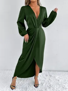 Detailansicht eines eleganten dunkelgrünen Satin-Maxikleids mit tiefem V-Ausschnitt und Schlitz
