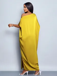 Back view of yellow satin maxi dress with off-the-shoulder design and side slit details