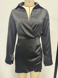 Detail of black satin long-sleeved dress with wrap neckline and pleated waist