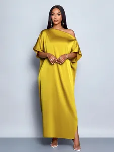 Detailed view of elegant mustard yellow satin maxi dress with one-shoulder design