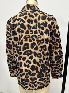Back view detail of a long-sleeved satin shirt featuring a classic leopard print