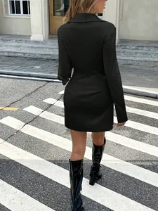 Back view of a chic black satin long-sleeved mini dress with a waist-cinching design