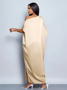 Detailed back view of a champagne satin maxi dress showing the flowing fabric and slit.