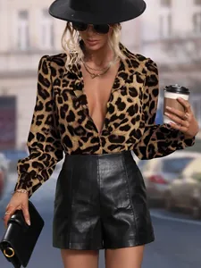 Close-up detail of a women's leopard print satin long-sleeve shirt in a street style setting