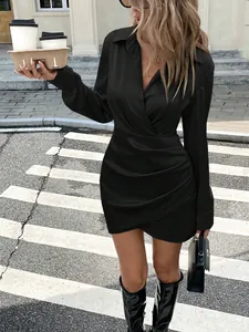 Full view of black satin long sleeve dress featuring ruched waist and v-neck detail