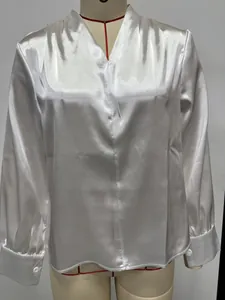 Detail view of white satin long sleeve blouse with V-neckline and elegant sheen
