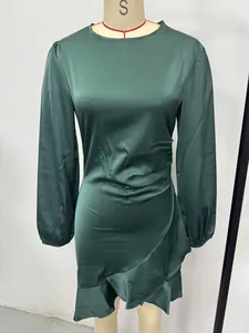 Close-up of emerald green satin long sleeve bodycon dress with fishtail hem