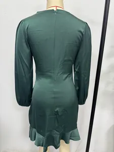 Back view of a deep green satin long-sleeved dress featuring a ruffled mermaid hemline