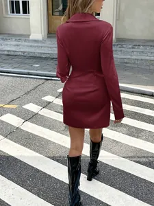 Back view of a burgundy long-sleeved satin dress with pleated waist and collar details