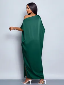 Detailed back view of an elegant dark green satin maxi dress featuring a side slit design