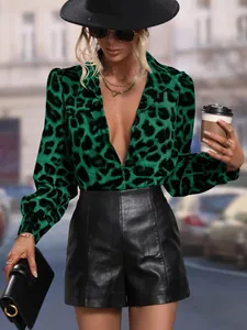 Detail view of green leopard print satin shirt featuring sexy deep V-neck and long sleeves