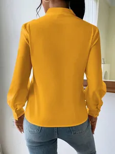 Back view of elegant yellow satin blouse showing smooth texture and loose fit design