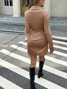 Detail showing back design of elegant champagne satin long-sleeved mini dress on zebra crossing
