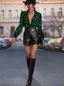 Full detail view of green leopard print satin shirt in a stylish street fashion setting