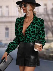 Fashion model posing in a vibrant green leopard print satin shirt and black leather shorts