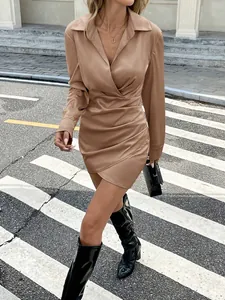 Elegant beige satin long sleeve mini dress with pleated waist and sophisticated wrap design