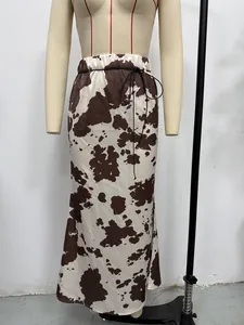 Macro view of the brown and white cow print satin maxi skirt with a drawstring waist detail