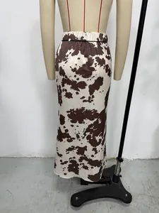Close-up detail of cow print satin maxi skirt back view shown on a mannequin stand