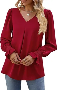 Detail view of red V-neck satin blouse with pleated front and ruffle smocked cuffs