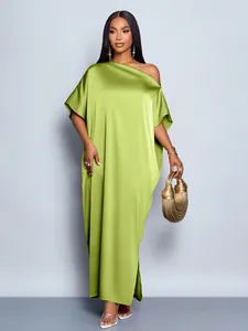Full-length detail of a lime green off-shoulder satin gown with elegant draping.