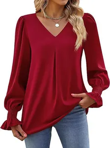 Close-up of a red satin V-neck blouse featuring elegant smocked bell cuffs